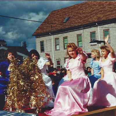 A color photograph of the girls on the Teen Queen float.