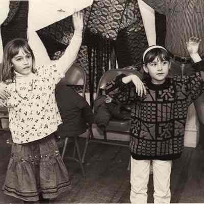 A photo view of two little girls doing exercises. 4/3/1992.
