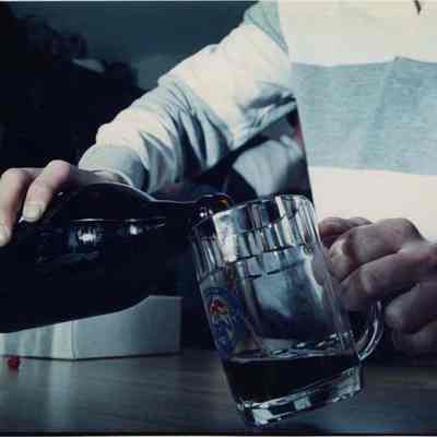 A photo view of someone pouring a beer. 4/25/1990.