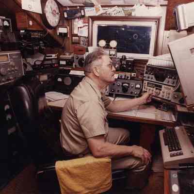 A photo view of a man operating some electronic gear. 11/9/1990.