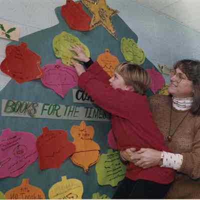 A photo view of Gaye Miller holding Caitlin Flannagan. 12/18/1991