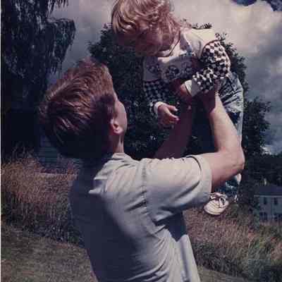 A photo view of a man and a child playing. 8/26/1988.