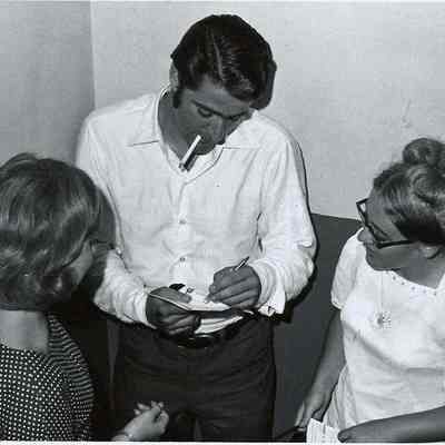 a member of the cast of Grease signing autographs.