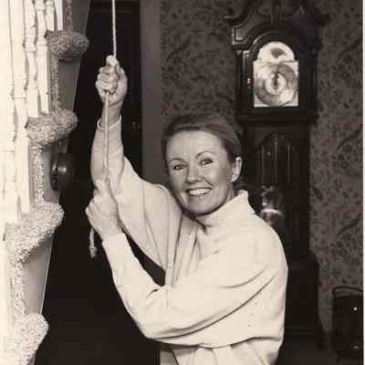 A photo view of a woman ringing a bell. 11/2/1982.