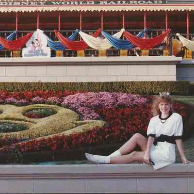 Lisa kelly relaxing by the flower garden at Disney World.