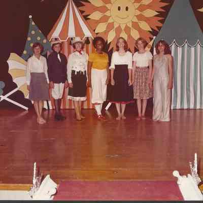 The seven contestants in talent costumes.