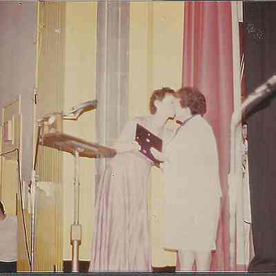 A color photograph of Sharon Hinckley giving Anita Theberge a hug.