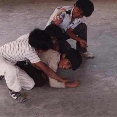 A photo view of 3 boys playing. 12/21/1990.