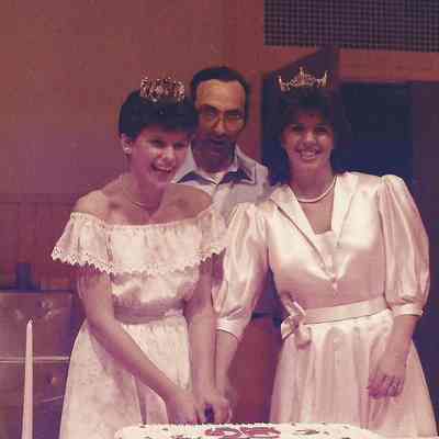 A color photograph of cutting the cake