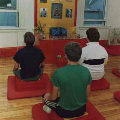 A photo view of 3 people doing yoga. 8/14/1987.