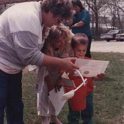 A photo view of a woman and 2 children. 5/19/1988.