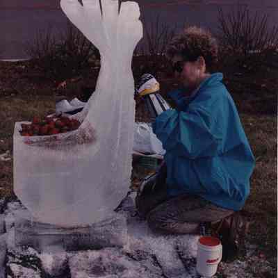 A photo view of a woman making an ice sculpture. 12/3/1990.