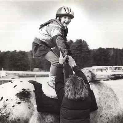 A photo view of a child on a horse.
