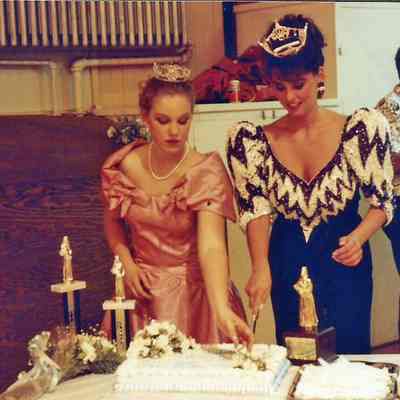 Katherine cutting cake & Darby Labbe is getting the cake distributed.