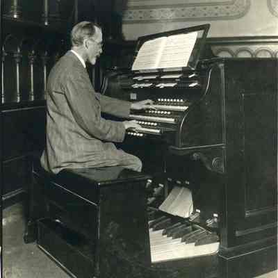 A photo of a man at the organ at King Chapel.