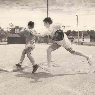 A photo view of two boys playing baseball.