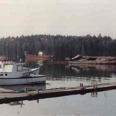 A photo view of a lobster boat tied up to a wharf. 10/31/1989.
