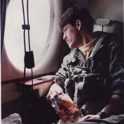 A photo view of a man on a plane. 3/19/1987.
