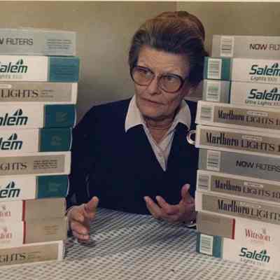 A photo view of a woman and cigarette packages. 11/17/1988.