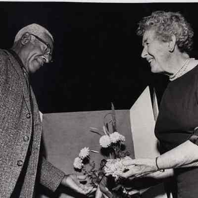 A photo view of Arthur Clayton showing some flowers.