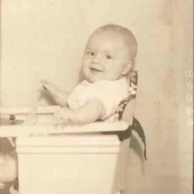 A photo of a baby in a high chair.