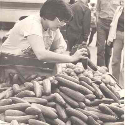 Boy Looking at a Truck Full of Cucumbers