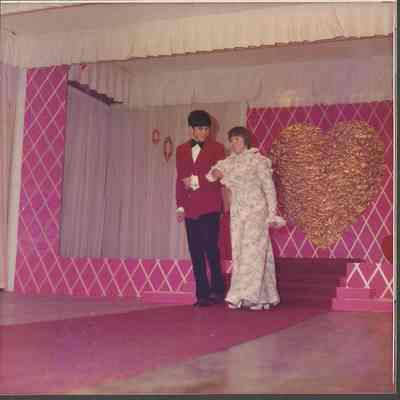 Contestant #8 Edith Morgan escorted to the microphone by Robert Cloutier.