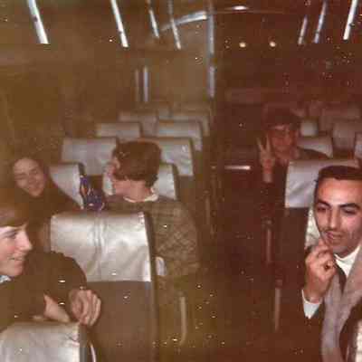 A color Polaroid photograph of people in an airplane. The man on the right is Gene Gagne.
