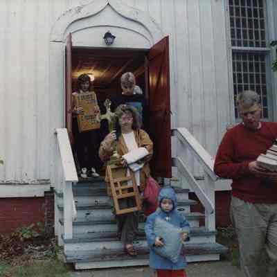 A photo view of people bringing things out of a church. 10/05/1990.