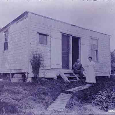 A couple outside a house.