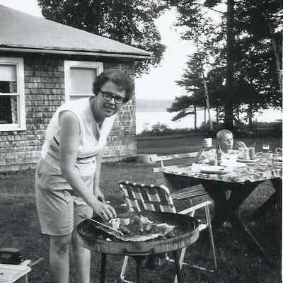 Unidentified Woman Cooking on a Grill
