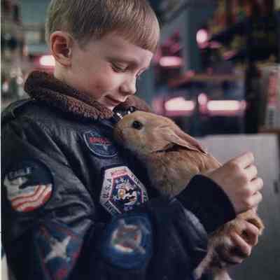 A photo view of a boy and his rabbit. 3/4/1989.