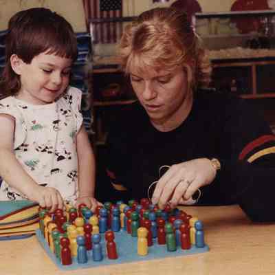 A photo view of a mother and child playing. 8/21/1989.