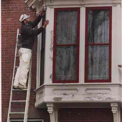 Workman Preparing to Paint the Skolfield-Whittier House
