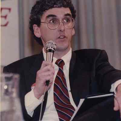 A photo view of a man on a microphone. 6/4/1992.