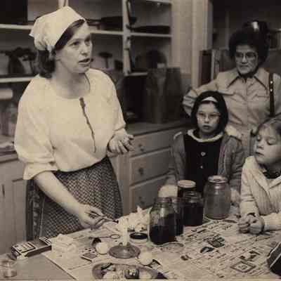 A photo view of showing kids how to color Easter eggs. 4/13/1981.