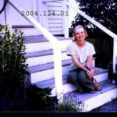 Photograph of Jeanne Yarborough sitting on her doorstep on School Street