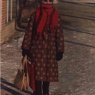 A photo view of a woman dressed for the cold. 12/31/1987.