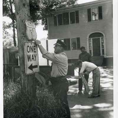 Policeman Hangs Sign