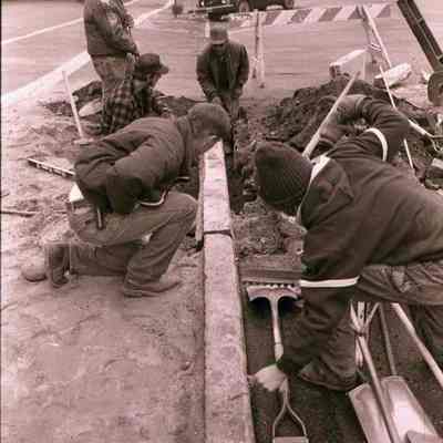 A photo view of sidewalk work being done. 11/27/1984
