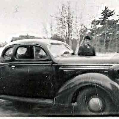 Unidentified Man Standing Beside a Car