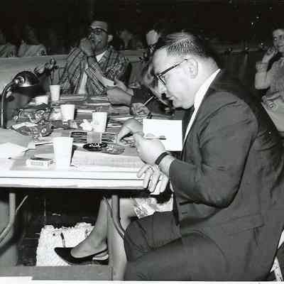 A B/W photograph of a group of people, could be judges.