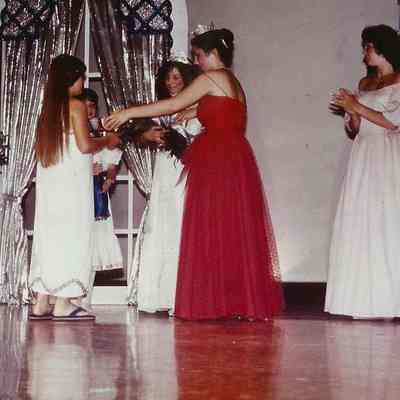 A color photograph of Kristi Kaknes presenting the trophy & flowers