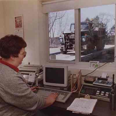 A photo view of a woman operating a computer. 5/20/1988.