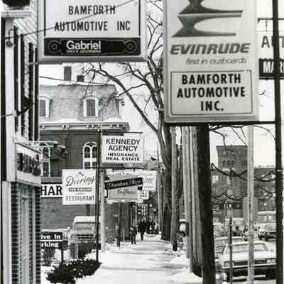 A photo of Maine St. Bamforth's Automotive to Fort Andross (telephoto lens). c.1970