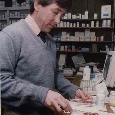 A photo view of a man filling prescriptions. 12/31/1991.