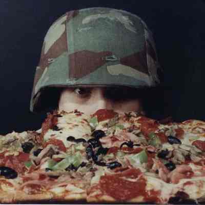 A photo view of someone looking at a pizza. 10/26/1989.
