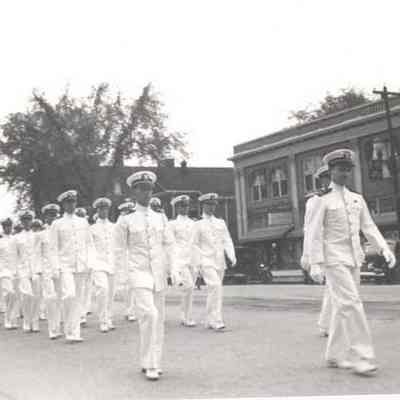 A photo view of a Navy marching unit in a parade.