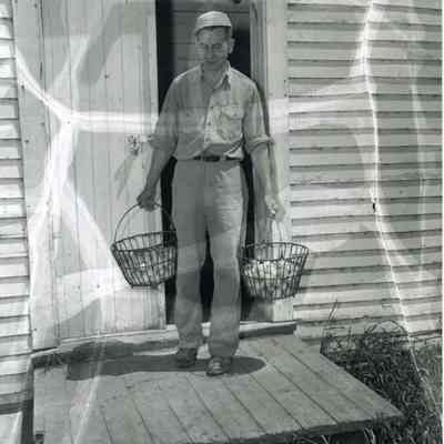 A photo of a man with some eggs.