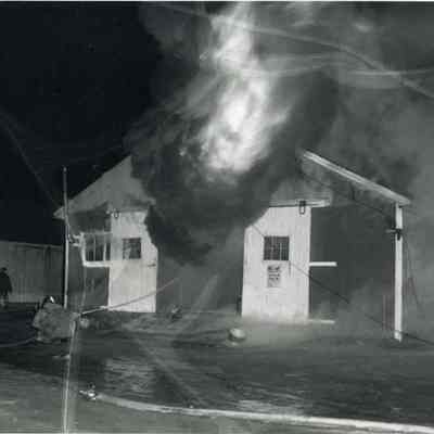 A photo of one of the animal sheds burning.